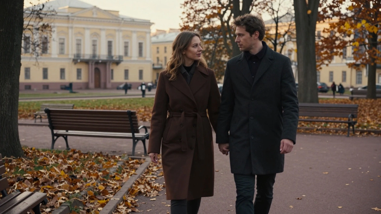 Two people walking side by side in an autumn park, sharing silent companionship under falling leaves.